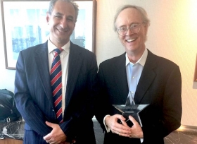 George Kinder (right) receiving his award from Andy Agathangelou